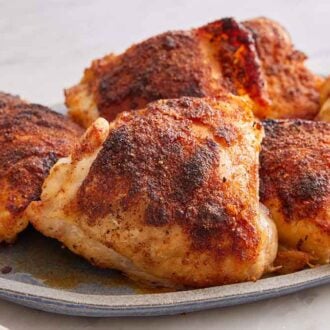 A platter of baked chicken thighs.