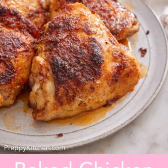 Pinterest graphic of a plate with four baked chicken thighs on it.