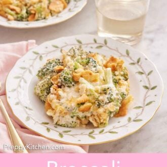 Pinterest graphic of two plates of broccoli casserole with a glass of wine inbetween.