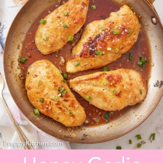 Pinterest graphic of an overhead view of a skillet with four honey garlic chicken breasts with sesame seeds and green onions on top.