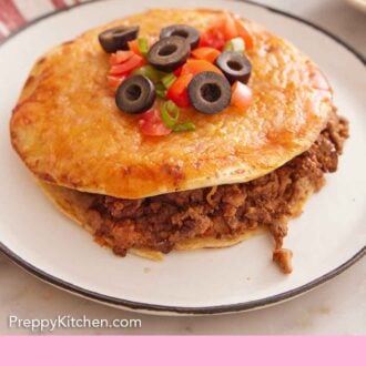 Pinterest graphic of a plate with a Mexican pizza with diced tomatoes, olives, and green onions on top with some ground beef spilling out.