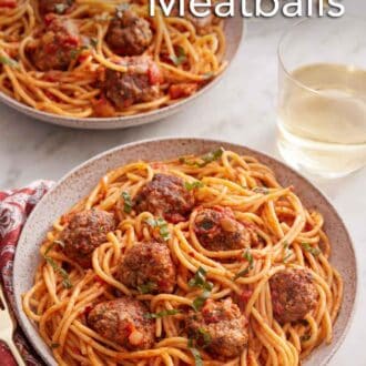 Pinterest graphic of two plates of spaghetti and meatballs with a glass of wine.