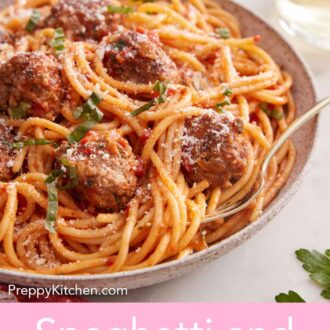 Pinterest graphic of a plate of spaghetti and meatballs with a fork tucked in with a glass of wine in the back.