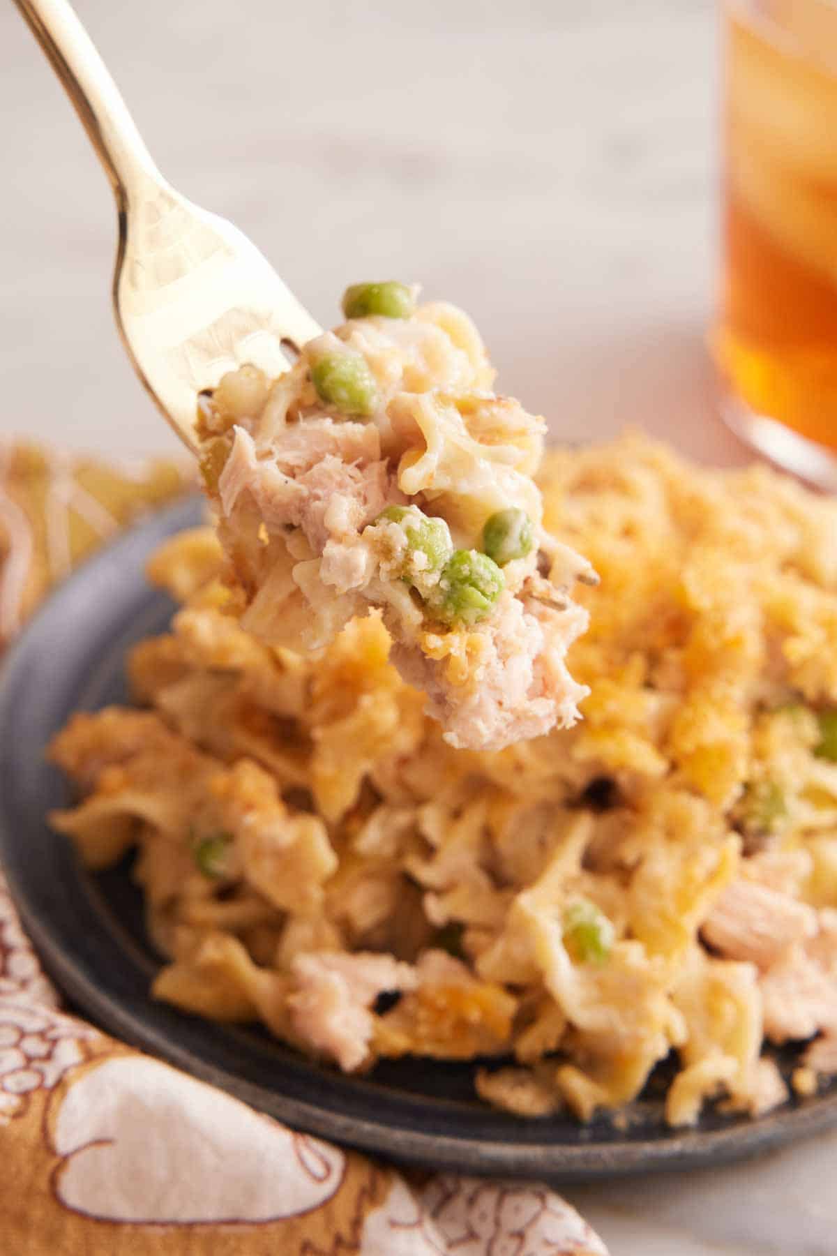 A forkful of tuna casserole lifted from a plate.