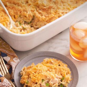 Pinterest graphic of a plate with a serving of tuna casserole with a baking dish full in the back.