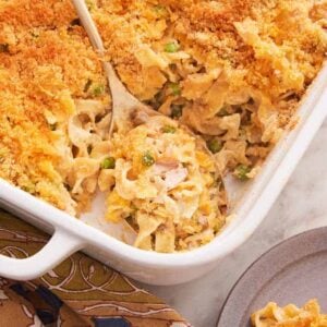 Overhead view of a spoonful of tuna casserole in a baking dish.
