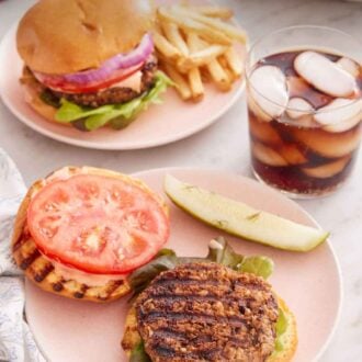 Pinterest graphic of a plate with an opened veggie burger with a drink on the side with another veggie burger in the background with fries.