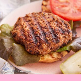 Pinterest graphic of a close up view of a grilled veggie burger on a bun.