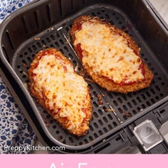 Pinterest graphic of two air fried chicken parmesans in an air fryer basket.