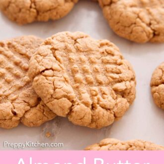Pinterest graphic of almond butter cookies scattered on a marble surface.