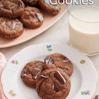 Pinterest graphic of a plate with three Andes Mint Cookies with a glass of milk and platter of cookies in the back.