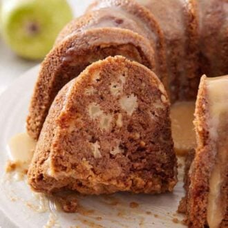 A close up view of a slice of apple bundt cake cut from the rest of the cake.