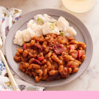 Pinterest graphic of a plate of baked beans with some potato salad.