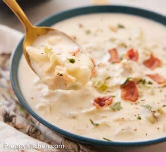 Pinterest graphic of a spoonful of clam chowder lifted from a bowl.