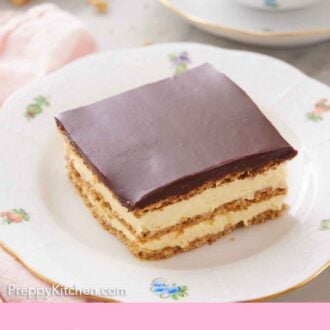 Pinterest graphic of a plate with a square slice of éclair cake with a cup of coffee in the back.