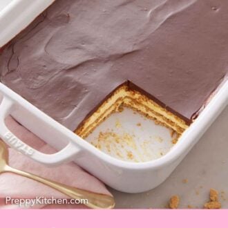 Pinterest graphic of a baking dish with a square slice of éclair cake cut out.