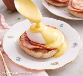Pinterest graphic of hollandaise sauce spooned over eggs benedict on a plate.