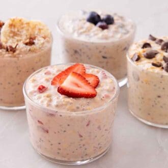 Four jars of overnight oats all topped with different toppings.