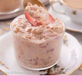 Pinterest graphic of a spoonful of overnight oats lifted from a glass with strawberry flavored overnight oats.