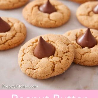 Pinterest graphic of multiple peanut butter blossoms with one slightly stacked on another.