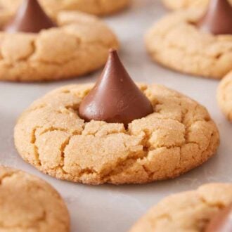 A side view of multiple peanut butter blossoms on a flat surface.