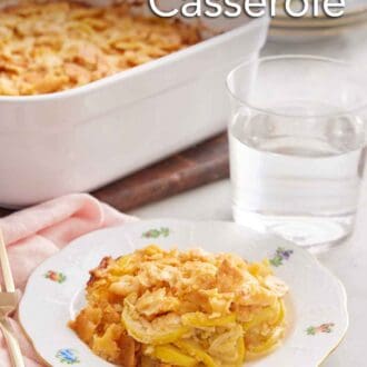 Pinterest graphic of a plate of squash casserole with a glass of water and baking dish in the background.