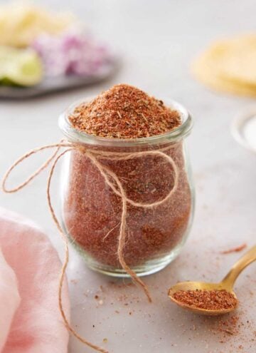 A small jar of taco seasoning with a string bow tied on.