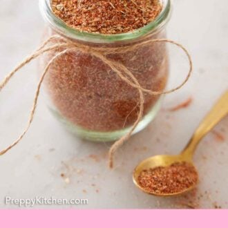 Pinterest graphic of a jar of taco seasoning with a spoonful places beside it.
