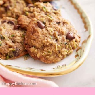 Pinterest graphic of a platte of zucchini cookies with one cookie in the front.