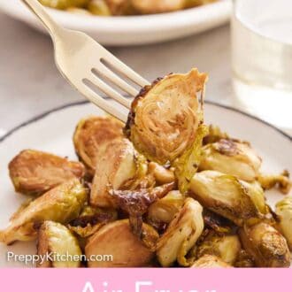 Pinterest graphic of a fork picking up an air fryer Brussels sprout from a plate.