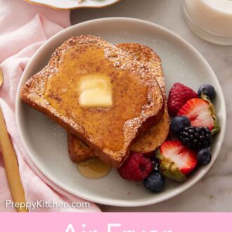 Pinterest graphic of overhead view of a plate of air fryer french toast with powdered sugar, syrup, butter, and berries.