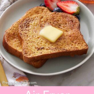 Pinterest graphic of a plate of air fryer french toast with berries with some maple syrup and a fork off to the side.