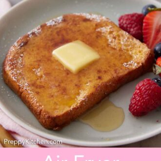 Pinterest graphic of a plate with one piece of air fryer french toast with berries.