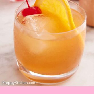 Pinterest graphic of a glass of Amaretto Sour with a slice of orange and maraschino cherry.