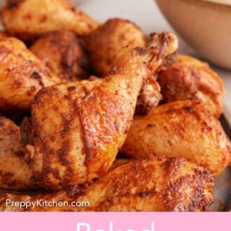 Pinterest graphic of a small pile of baked chicken legs on a platter. Mashed potatoes and salad in the background.