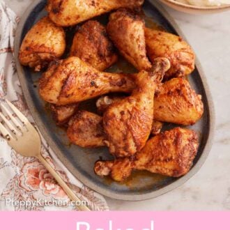 Pinterest graphic of overhead view of a platter of baked chicken legs. Side dishes off to the side.