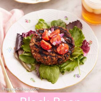 Pinterest graphic of a plate with a black bean burger patty topped with tomatoes and red onions over a bed of lettuce. More patties in the background.