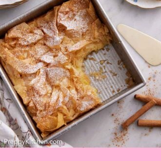 Pinterest graphic of an overhead view of a baking pan of Bougatsa with a serving cut out.