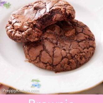 Pinterest graphic of a plate with two brownie cookies, one with a bite taking out of it.