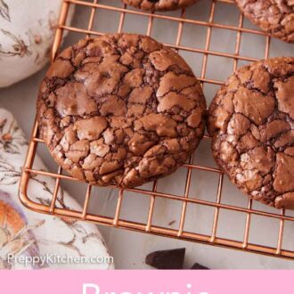 Pinterest graphic of an overhead view of brownie cookies on a cooling rack.