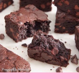 Pinterest graphic of multiple brownies on a flat surface with one in the middle torn open.