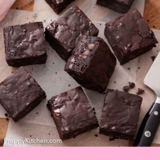 Pinterest graphic of cut brownies on a parchment lined wooden board.