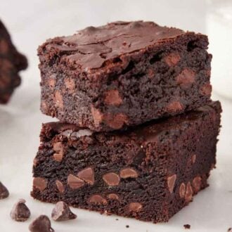 A stack of two brownies with more around it.