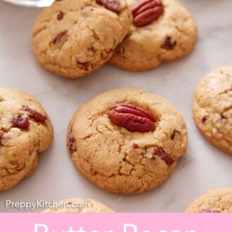 Pinterest graphic of multiple butter pecan cookies scattered on a marble counter with a glass of milk.