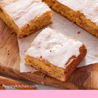 Pinterest graphic of two slices of honey bun cake sliced from the whole cake on a wooden serving board.