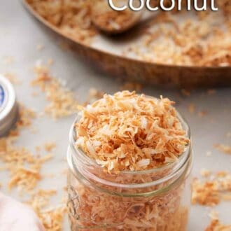 Pinterest graphic of a jar of toasted coconut with a skillet in the background with more coconut.