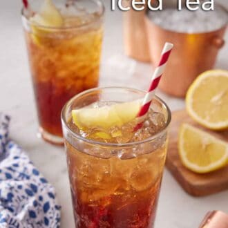 Pinterest graphic of two glasses of Long Island Iced Tea with sliced lemon and straws.