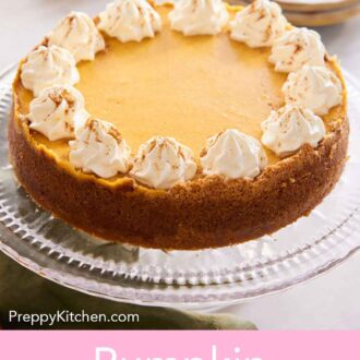 Pinterest graphic of a pumpkin cheesecake on a cake stand with dollops of whipped cream and a dusting of pumpkin pie spice on top.