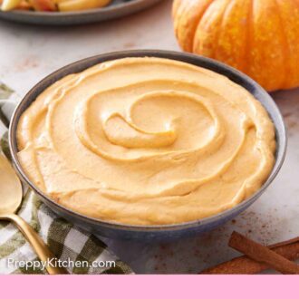 Pinterest graphic of a bowl of pumpkin dip with crackers, apples, and pumpkin in the background.