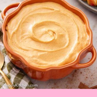 Pinterest graphic of a pumpkin-shaped bowl containing pumpkin dip with some apple slices on the side.